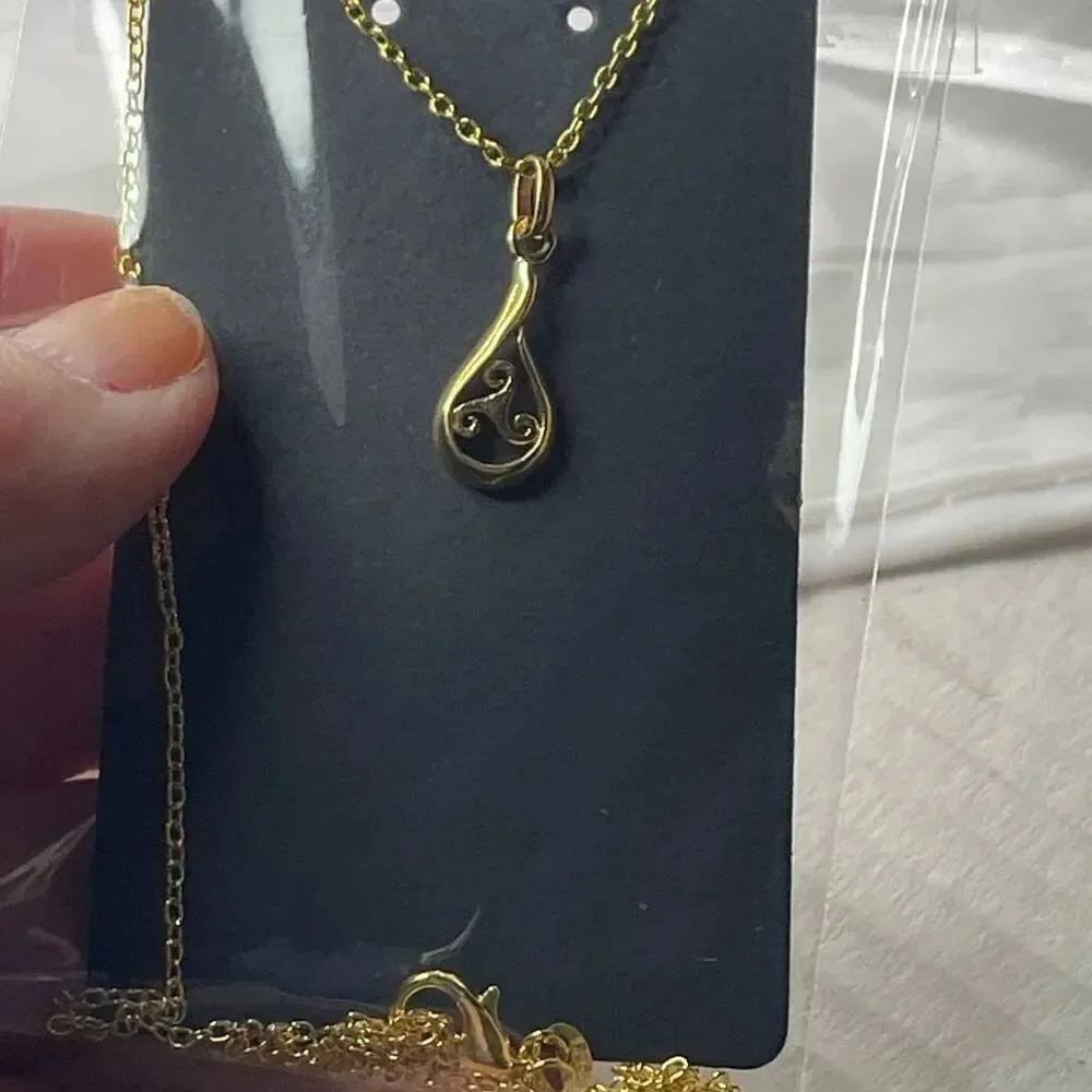Sterling silver gold plated open work teardrop pendant and chain.